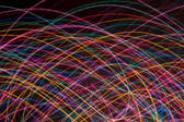 multicoloured crisscrossing curved lines of coloured light on a black background. I used this composition for my twitter background http:/twitter.com/Creativity103