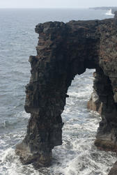 black volcanic rock arch at Holei on the coast of Hawaiis Big Island