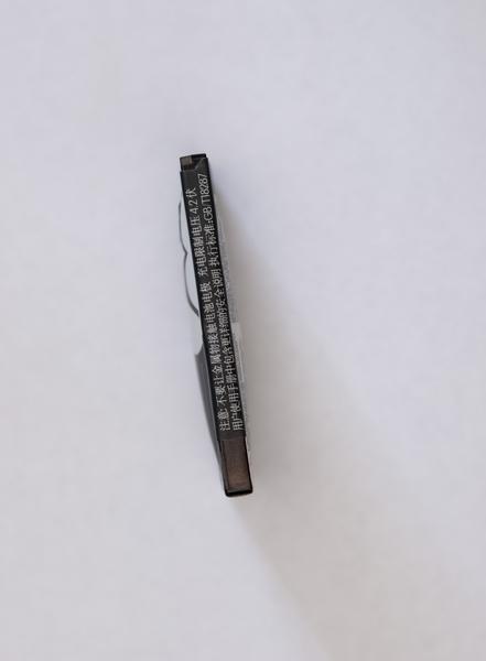 A defective cell phone lithium ion battery which has expanded out of shape