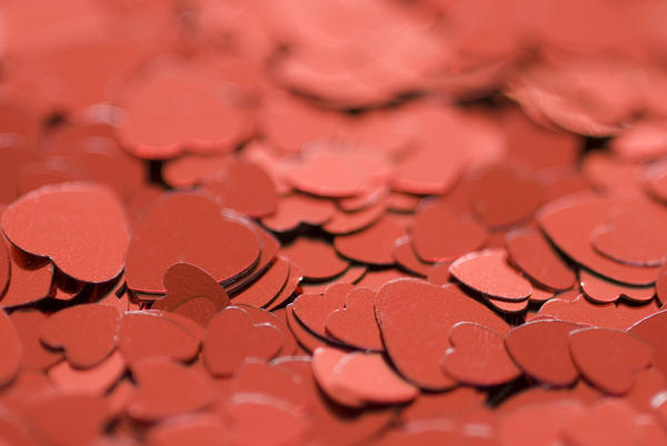 a background of metallic red heart symbols