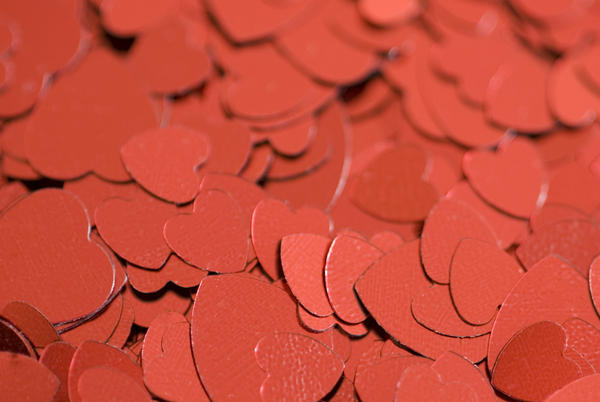 a background of metallic red heart symbols