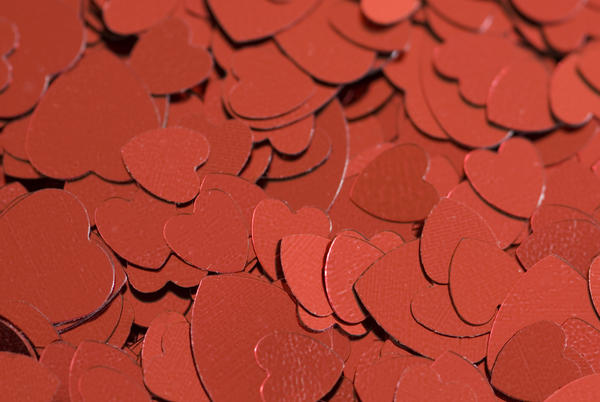 a background of metallic red heart symbols