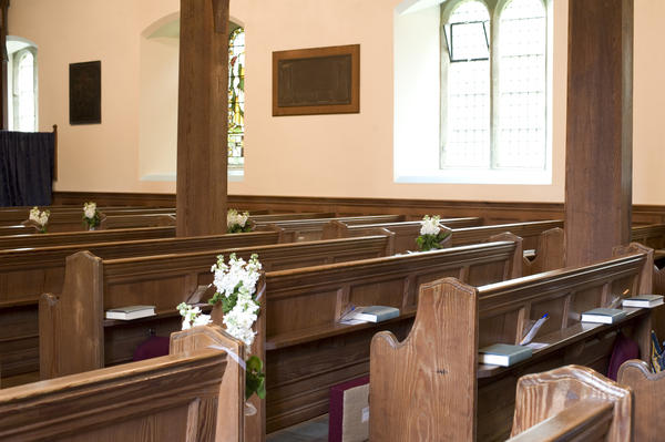rows of traditional church pews in a small village church
