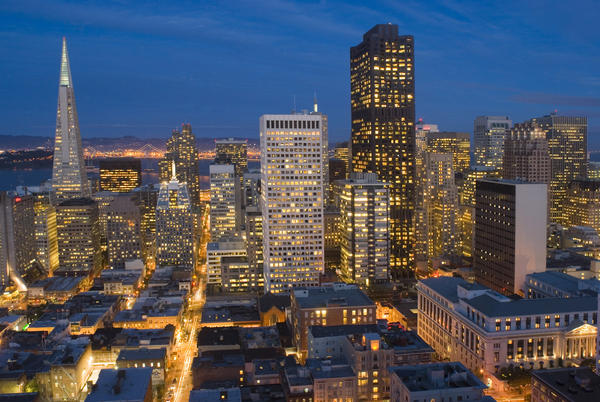 brightly lit cityscape of san francisco downtown in the late evening