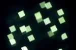 defocused camera effect, green lights create square bokeh