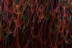 moving lines of light create a festive background of light on a black backdrop