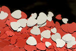 a background image featuring reflective heart shaped confetti in metallic silver and red colours
