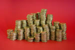piles of money stacked up in gold coloured coins