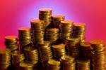 piles of money and wealth: coins stacked up on a colorful background