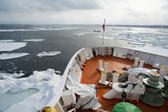 Bows of the Aurora icebreaker clearing a channel for shipping through the winter drift ice in the ocean off Hokkaido