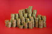 piles of money stacked up in gold coloured coins