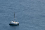 Luxury sailing catamaran moored offshore in mid ocean for a tropical vacation with copyspace