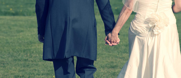 cross processed image of a wedding couple holding hands