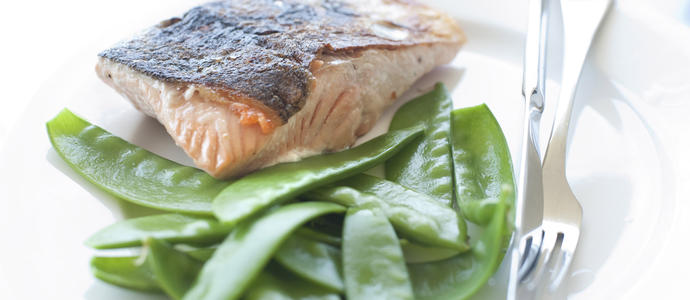 Pan fried salmon steak served with succulant sugarsnap peas in their pods